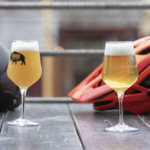 glasses of beer with bike helmets