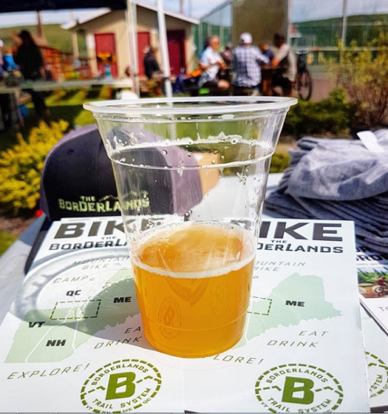 A beer sits on a Bike Borderlands map