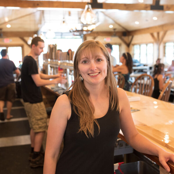 A young woman bartender at Raquette River Brewing, Tupper Lake