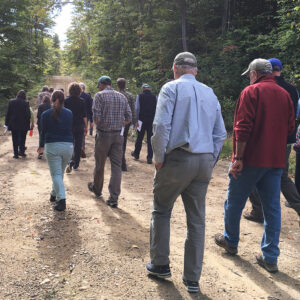 A group of hikers on a dirt road path