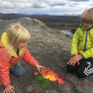 children play on the summit after a hike in the Adirondacks