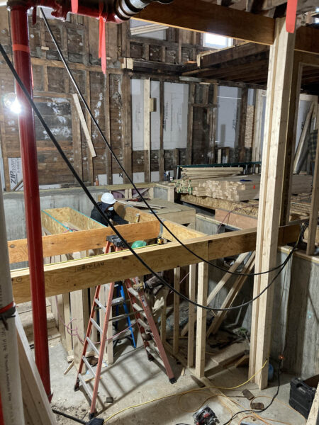 Construction workers build structure for elevator and stairs in Parker J. Noyes building in Lancaster, NH.