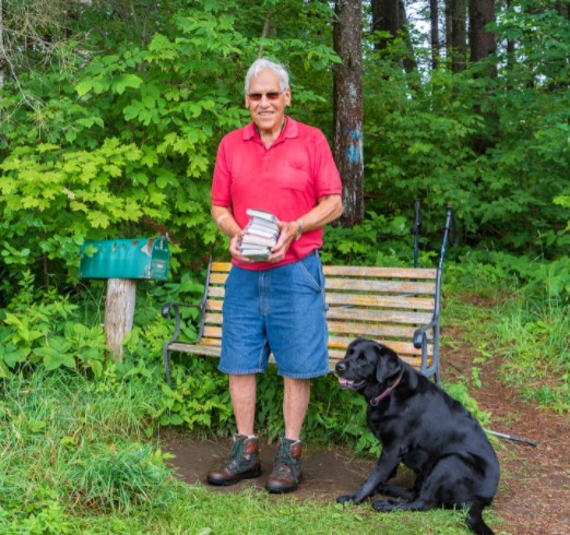 St. Johnsbury resident David Brown and his dog on land he donated to town.