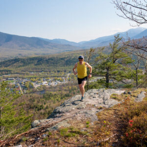 Man runs on trail in northern New Hampshire.