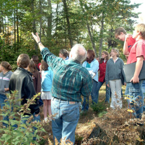 Students and teacher in forest classroom seeting