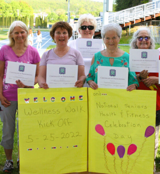 Walkers show off their wellness certificates