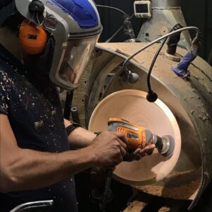 Wood turner finishes a bowl on the lathe