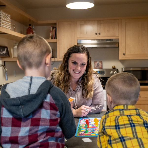 Woman and children in new apartment kitchen.