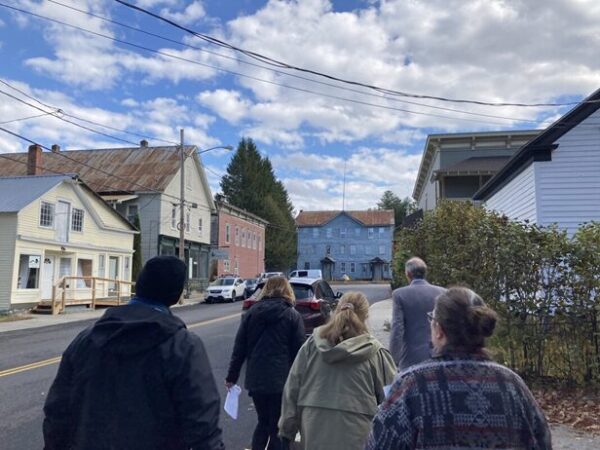 Two men and one woman tour the proposed historic district in the hamlet of Chestertown.