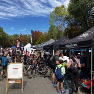 People look at displays at a mountain bike riding competition.