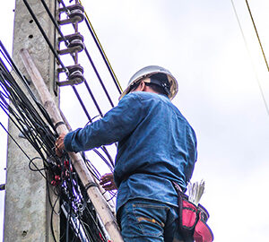 Lineman installing fiber optic cable.