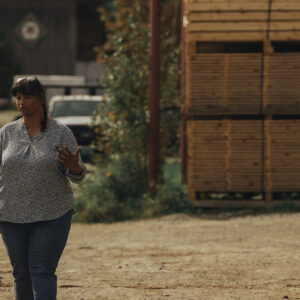 Two women discuss business at a lumber mill