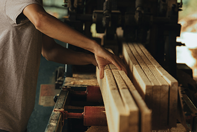 Hans guide boards at a sawmill