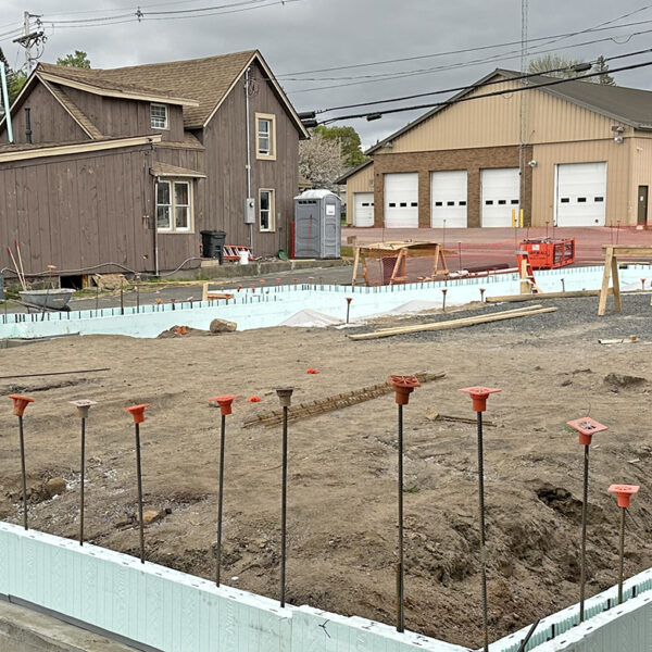 Construction site with foundation poured for a new apartment building.