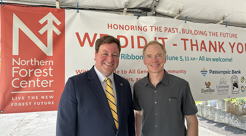 two men standing in front of a banner
