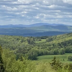 Green rolling hills and distant mountains of northern Vermont