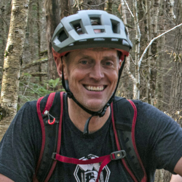 Male mountain biker wearing helmet.