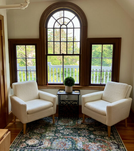 armchairs in front of Palladian window
