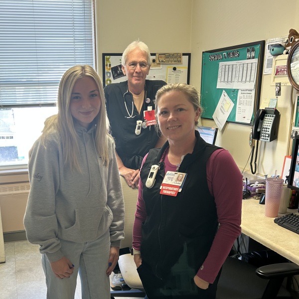 young women stands in office with workplace mentors