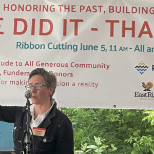woman speaks at building celebration